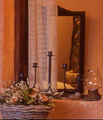 A basket of flowers sits on a window sill