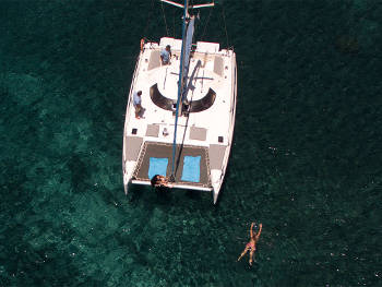 Sailing through Santorini's white beach